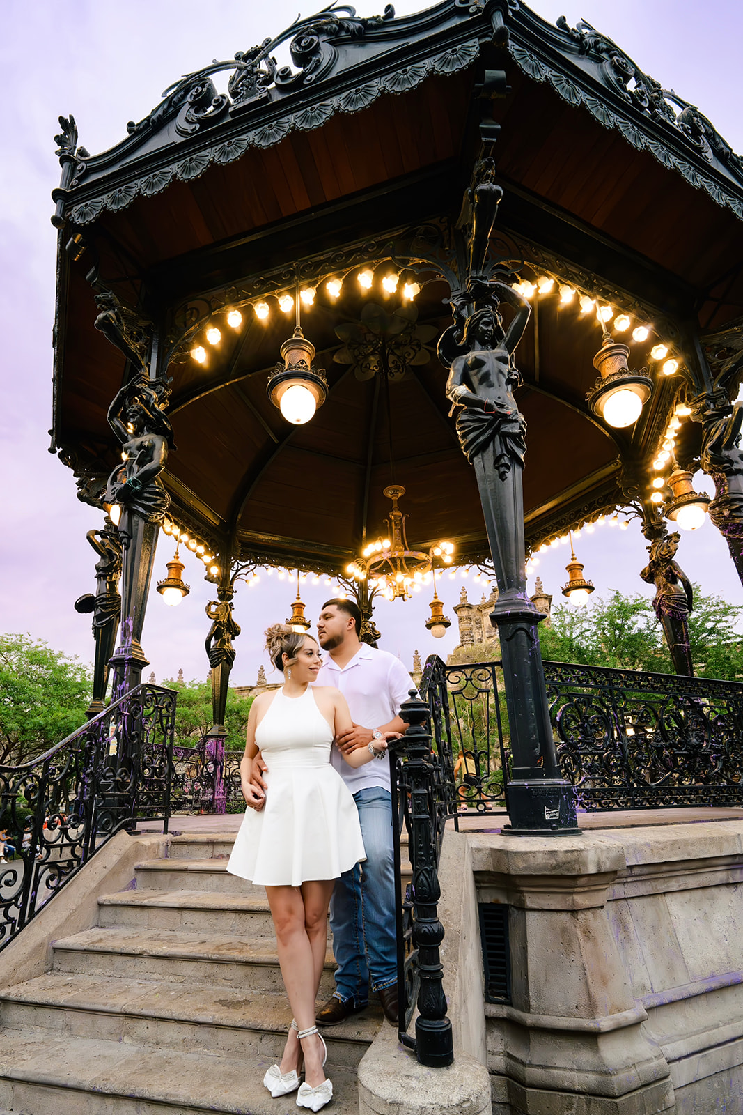 Couple kissing in romantic city plaza setting