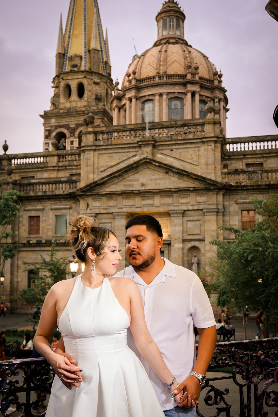 Couple embracing in front of historic cathedral